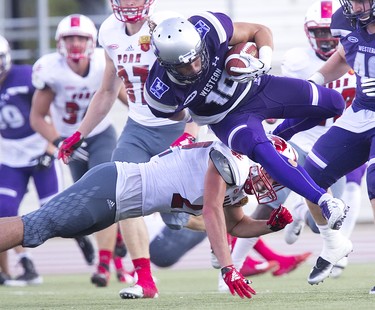 Western Mustang Mike Sananes is upended  by Matt Dean of the York Lions during their football game at TD Stadium in London, Ont. on Saturday September 15, 2018. The Mustangs won the game by a score of 76-3. Derek Ruttan/The London Free Press/Postmedia Network