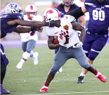 York Lion ball carrier Kadeem Hemmings gets his head spun by Okwes Nwaelleh of the Western Mustangs during their football game at TD Stadium in London, Ont. on Saturday September 15, 2018. The Mustangs won the game by a score of 76-3. Derek Ruttan/The London Free Press/Postmedia Network