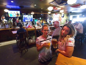 Popular Oakridge sports bar The Oarhouse is closing. Bartender Heather Ciskowski and manager Kristen Gordon sadly toast its long run in London, Ont.  Photograph taken on Tuesday September 18, 2018.  Mike Hensen/The London Free Press/Postmedia Network