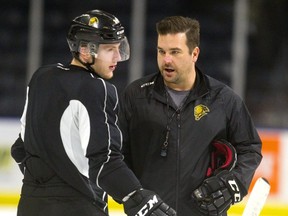 Knights assistant coach Dylan Hunter talks to Andrew Perrott as practice winds down at Budweiser Gardens.  (Mike Hensen/The London Free Press)