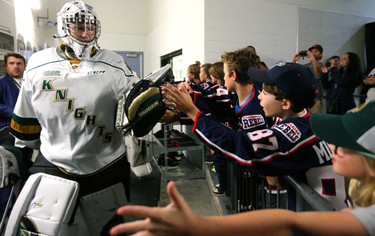 Goaltender Jordan Kooy  of the London Knights high fives fans as he leads the team onto the ice for their first game of the season against the Windsor Spitfires at Budweiser Gardens  on Friday Sept. 21.  Mike Hensen/The London Free Press