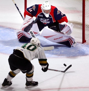 Antonio Stranges of the London Knights reaches for a pass in front of Michael DiPietro of the Wiindsor Spitfires as the clock hits 0:00 at the end of the first period during the Knights home opener at Budweiser Gardens on Friday Sept. 21.  Mike Hensen/The London Free Press