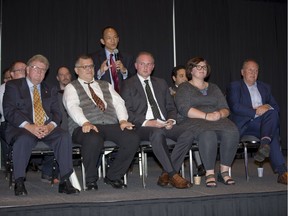 Paul Cheng speaks while other mayoral hopefuls listen during a debate at the London Convention Centre Wednesday. The candidates sitting in the front row are Ed Holder, Dan Lenart, Sean O’Connell, Tanya Park and Paul Paolatto. (DEREK RUTTAN, The London Free Press)