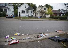 Litter is strewn across Broughdale Avenue the day after a large "fake homecoming" street party in London, Ont. on Sunday September 30, 2018. (Derek Ruttan/The London Free Press)