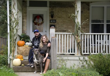 Embracing autumn: Autumn’s bounty enhances the porch of Laura Nelligan, Julain Warnock and their dog Cao. They decorated their London house at 431 Emery St. with fall finery purchased at  Howe Family Farm Market in Aylmer.  (DEREK RUTTAN, The London Free Press)