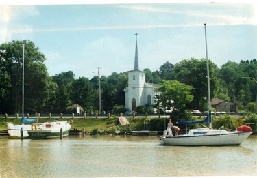 Boaters pass Christ Church (English Church in the early 1900s) in Port Stanley, 1985. (London Free Press files)