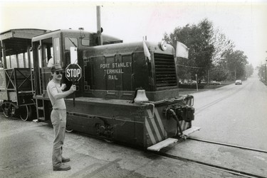 Port Stanley Terminal Rail. Greg Steele acts as flagman where the rail line crosses Warren Street, 1984. (London Free Press files)