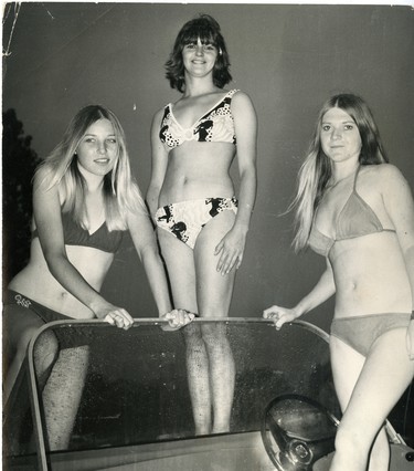 Three contestants seeking the Miss Water Festival title in Port Stanley pose on top of a boat. From left are Vicky Peterson, Vaunise Cosby and Vivian Harrietha, 1972.  (London Free Press files)
