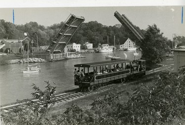 Port Stanley Terminal Rail excursion train, boaters heading in from Lake Erie under the King George VI lift bridge, 1983. (London Free Press files)