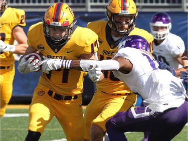 Queen's Golden Gaels Zackary Kealey tries to get past Western Mustangs Bleska Kambamba during their Ontario University Athletics football game in Kingston Saturday Sept. 9 2018. Western won 26-23.   Ian MacAlpine/Postmedia Network