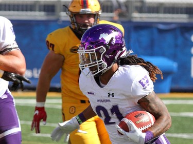 Western Mustangs Cedric Joseph runs past Queen's Golden Gaels during their Ontario University Athletics football game in Kingston Saturday Sept. 9 2018. Western won 26-23.   Ian MacAlpine/Postmedia Network