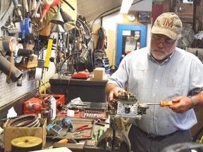Louie Sylvain rebuilds a boat carburetor in his shop, Sylvain's Marine, on the southeast side of Sarnia. The marine mechanic has been in the industry for more than four decades, and cannot find anyone to take over his business. (Louis Pin/The Observer)