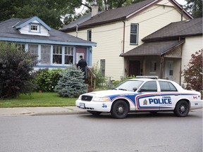 Police canvas residents of Blackfriars Street looking for information about a weekend shooting in London, Ont. on Sunday September 30, 2018.  One Friday evening a woman was shot and is now in critical condition in hospital. A man was arrested and a firearm seized at the scene. Derek Ruttan/The London Free Press/Postmedia Network