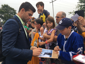 Leafs forward John Tavares signs an autograph for Nathan McEwan, 12, on 2018 Kraft Hockeyville game day before practice at the Lucan Community Memorial Centre. (Jennifer Bieman/The London Free Press)