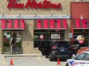 London police surround a Tim Hortons location on Dundas Street at Industrial Road after a man was shot on Wednesday Sept. 12, 2018. He later died. (Mike Hensen/The London Free Press) MIKE HENSEN / MIKE HENSEN/THE LONDON FREE PRES