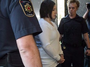 Terri-Lynne McClintic is escorted into court in Kitchener, Ont., on Wednesday, September 12, 2012. The bureaucrat charged with reviewing the controversial transfer of Tori Stafford's killer from a medium security prison to an Indigenous healing lodge says she is comfortable with the decision to move Terri-Lynne McClintic.