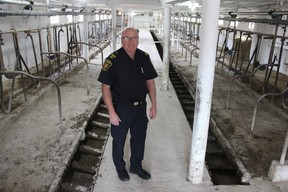 John Elston, fire prevention officer with Middlesex County, stands in the middle of dairy farm in Arva. He says barn fires are so complex, education is the first line of defence to avoid large losses of livestock. JONATHAN JUHA/THE LONDON FREE PRESS