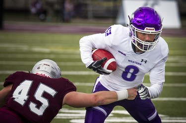 The Western Mustangs were in Ottawa to play the uOttawa Gee-Gees Saturday October 13, 2018 at the Gee-Gees Field. Mustangs # 8 Francois Rocheleau tries to get past Gee-Gees #45 Jason-Lee Jones.  Ashley Fraser/Postmedia