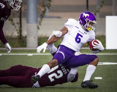 The Western Mustangs were in Ottawa to play the uOttawa Gee-Gees Saturday October 13, 2018 at the Gee-Gees Field. Mustangs #5 Alex Taylor gets tackled by an Ottawa Gee-Gees player.   Ashley Fraser/Postmedia
