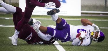 The Western Mustangs were in Ottawa to play the uOttawa Gee-Gees Saturday October 13, 2018 at the Gee-Gees Field. Mustangs #5 Alex Taylor gets tackled by Ottawa Gee-Gees players.   Ashley Fraser/Postmedia