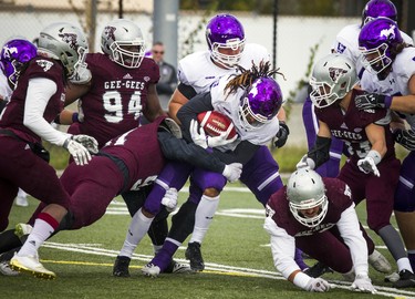 The Western Mustangs were in Ottawa to play the uOttawa Gee-Gees Saturday October 13, 2018 at the Gee-Gees Field. Western Mustangs #21 Cedric Joseph holds the ball while getting tackled.   Ashley Fraser/Postmedia