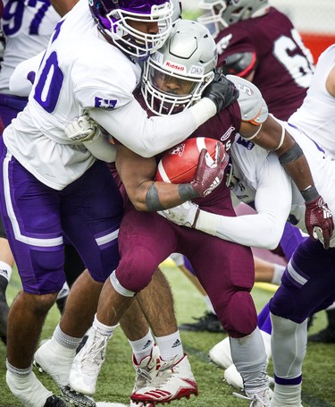 The Western Mustangs were in Ottawa to play the uOttawa Gee-Gees Saturday October 13, 2018 at the Gee-Gees Field. Gee-Gees #24 Dawson Odei tries to get the ball away from the Mustangs.   Ashley Fraser/Postmedia