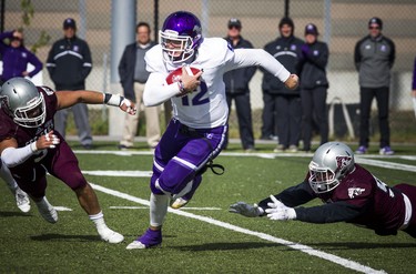 The Western Mustangs were in Ottawa to play the uOttawa Gee-Gees Saturday October 13, 2018 at the Gee-Gees Field. Mustangs #12 Chris Merchant gets the ball away from the Gee-Gees Saturday afternoon.   Ashley Fraser/Postmedia