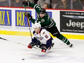 Defenceman William Lochead #4 of the London Knights trips forward Luke Boka #61 of the Windsor Spitfires on October 4, 2018 at the WFCU Centre in Windsor, Ontario, Canada. (Photo by Dennis Pajot/Getty Images)