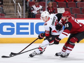 Alex Formenton of the Senators drives past the Coyotes' Jason Demers, drawing a minor penalty during the second period.