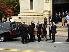 Mourners gather as a casket is carried outside the Rodef Shalom Congregation where the funeral for Tree of Life Congregation mass shooting victims Cecil Rosenthal and David Rosenthal on Tuesday. (BRENDAN SMIALOWSKI/AFP/Getty Images)