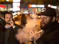 People smoke Cannabis on the street in Toronto on Wednesday October 17, 2018. Midnight signalled the legalization of Cannabis across Canada.