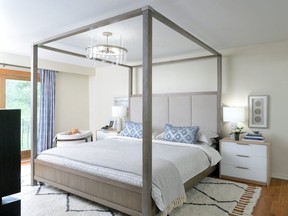 Lisa Canning loves the drama that a canopy bed — with its natural wood texture and  upholstered high headboard — creates.