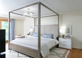 Lisa Canning loves the drama that a canopy bed — with its natural wood texture and  upholstered high headboard — creates.