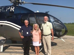 Dean Bass, left, is shown in August with Evelyn Alemanni and Jim Baird, judges with Communities in Bloom. He took them for a helicopter ride as part of their visit to Sarnia. Bass, a helicopter pilot with Enbridge, died this week in a helicopter crash in a remote area of Wisconsin during a routine pipeline monitoring and inspection flight. HANDOUT