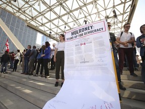 Anti-Ford protesters sign a mock Charter of Rights to be sent to Caroline Mulroney at Toronto city hall over the reduction of the number of council seats saw hundreds of people show up to voice their disdain along with MPPs and some city councillors and union reps  on Wednesday September 12, 2018. Jack Boland/Toronto Sun/Postmedia Network