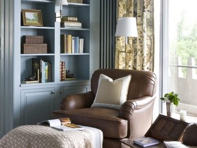 An ottoman helps turn a comfortable living room chair into the perfect place for reading, exemplified by this home library designed by Kelley Proxmire.  (Angie Seckinger/Sherry Moeller)