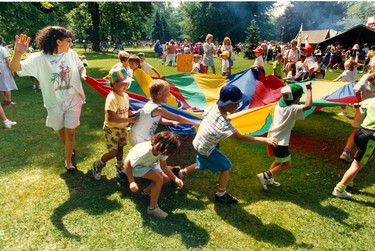 Pupils from Errol Road Public School in Sarnia whirl with parachute silk in the Playing Green of Victoria Park at International Children's Festival, 1991. (London Free Press files)