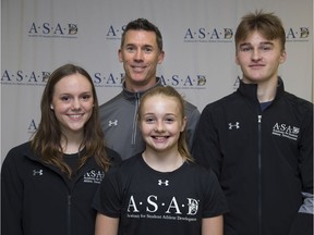 Lead teacher Keith Heard stands with Academy for Student Athlete Development students: Grade 11 figure skater Payton Beckett, left, Grade 9 gymnast Chloe Burridge and Grade 10 hockey player Cole Watson in London on Tuesday. The Thames Valley District school board is expanding into training of elite high school athletes. (Derek Ruttan/The London Free Press)