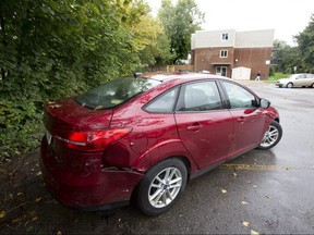 Three vehicles, including this one, were struck by a stolen vehicle in the parking lot of an apartment complex on Noel Avenue on Monday. A police officer fired three shots through the stolen car's windshield during the arrest of a suspect, witnesses said. (Derek Ruttan/The London Free Press)
