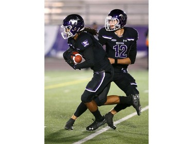 Cedric Joseph gets a handoff from Mustangs quarterback Chris Merchant at his own 20 and goes untouched for a 90-yard touchdown run against the Windsor Lancers during their night game at TD Stadium in London Thursday. (Mike Hensen/The London Free Press)