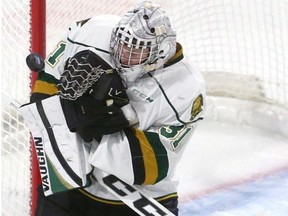 Knights goalie Jordan Kooy covers up on a high shot off his shoulder during their game at Budweiser Gardens on Friday Oct. 5, 2018 against the Owen Sound Attack. (Mike Hensen/The London Free Press)