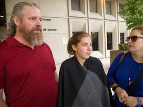 Kevin Williams talks to Jane Sims with his daughter Olivia, 13 and wife Victoria Williams after court on Thursday. (Mike Hensen/The London Free Press)