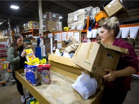 Fanshawe College social services students Ashley Williams and Jessica Boudreault sort donations to the London Food Bank's Thanksgiving food drive, which topped last year's tally thanks to a last-minute surge in donations, officials say. (MIKE HENSEN/ The London Free Press)