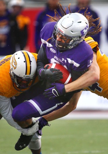 Western running back Cedric Joseph gets spun around by Laurier's Daishane Johnson and Scott Hutter as he tries for a short touchdown run    early in the Western Homecoming game on Saturday October 20, 2018 at TD stadium.
The Mustangs won 46-13 after a strong second half against the Golden Hawks, leaving them undefeated for the season.
Mike Hensen/The London Free Press/Postmedia Network