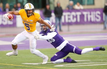 Western cornerback Jake Lindley just won't let go of Laurier wide reciever Brentyn Hall in the Western Homecoming game on Saturday October 20, 2018 at TD stadium.
The Mustangs won 46-13 after a strong second half against the Golden Hawks, leaving them undefeated for the season.
Mike Hensen/The London Free Press/Postmedia Network