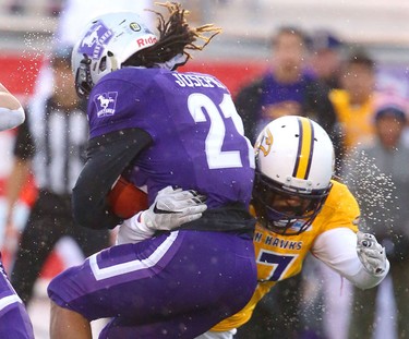 Western running back Cedric Joseph gets hit behind the line by Laurier defensive end Alfred Green for a loss in the Western Homecoming game on Saturday October 20, 2018 at TD stadium.
The Mustangs won 46-13 after a strong second half against the Golden Hawks, leaving them undefeated for the season.
Mike Hensen/The London Free Press/Postmedia Network