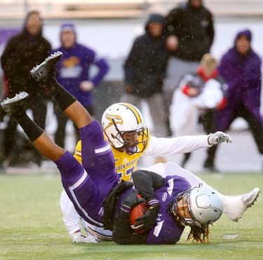 Western running back Cedric Joseph gets hit behind the line by Laurier defensive end Alfred Green for a loss in the Western Homecoming game on Saturday October 20, 2018 at TD stadium.
The Mustangs won 46-13 after a strong second half against the Golden Hawks, leaving them undefeated for the season.
Mike Hensen/The London Free Press/Postmedia Network