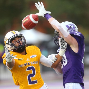 Western halfback Jake Andrews knocks away a pass intended for Laurier slot back Esson Hamilton in the Western Homecoming game on Saturday October 20, 2018 at TD stadium.
The Mustangs won 46-13 after a strong second half against the Golden Hawks, leaving them undefeated for the season.
Mike Hensen/The London Free Press/Postmedia Network