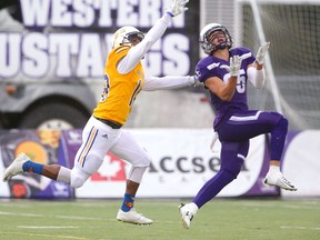 Western wide receiver Malik Besseghieur runs under a pass by Chris Merchant for a long gain against Laurier's Daishane Johnson during the Western Homecoming game on Saturday October 20, 2018 at TD stadium.
The Mustangs won 46-13 after a strong second half against the Golden Hawks, leaving them undefeated for the season.
Mike Hensen/The London Free Press/Postmedia Network