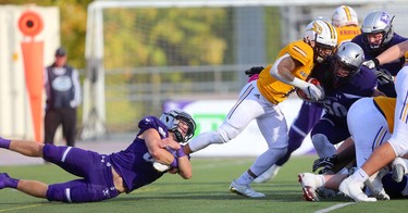 Western linebacker Fraser Sopik holds on to Laurier running back Levondre Gordon till the calvary arrives in the Western Homecoming game on Saturday October 20, 2018 at TD stadium.
The Mustangs won 46-13 after a strong second half against the Golden Hawks, leaving them undefeated for the season.
Mike Hensen/The London Free Press/Postmedia Network